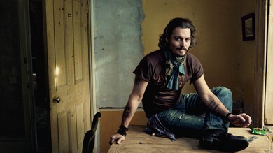 Actor Johnny Depp Sitting on The Table